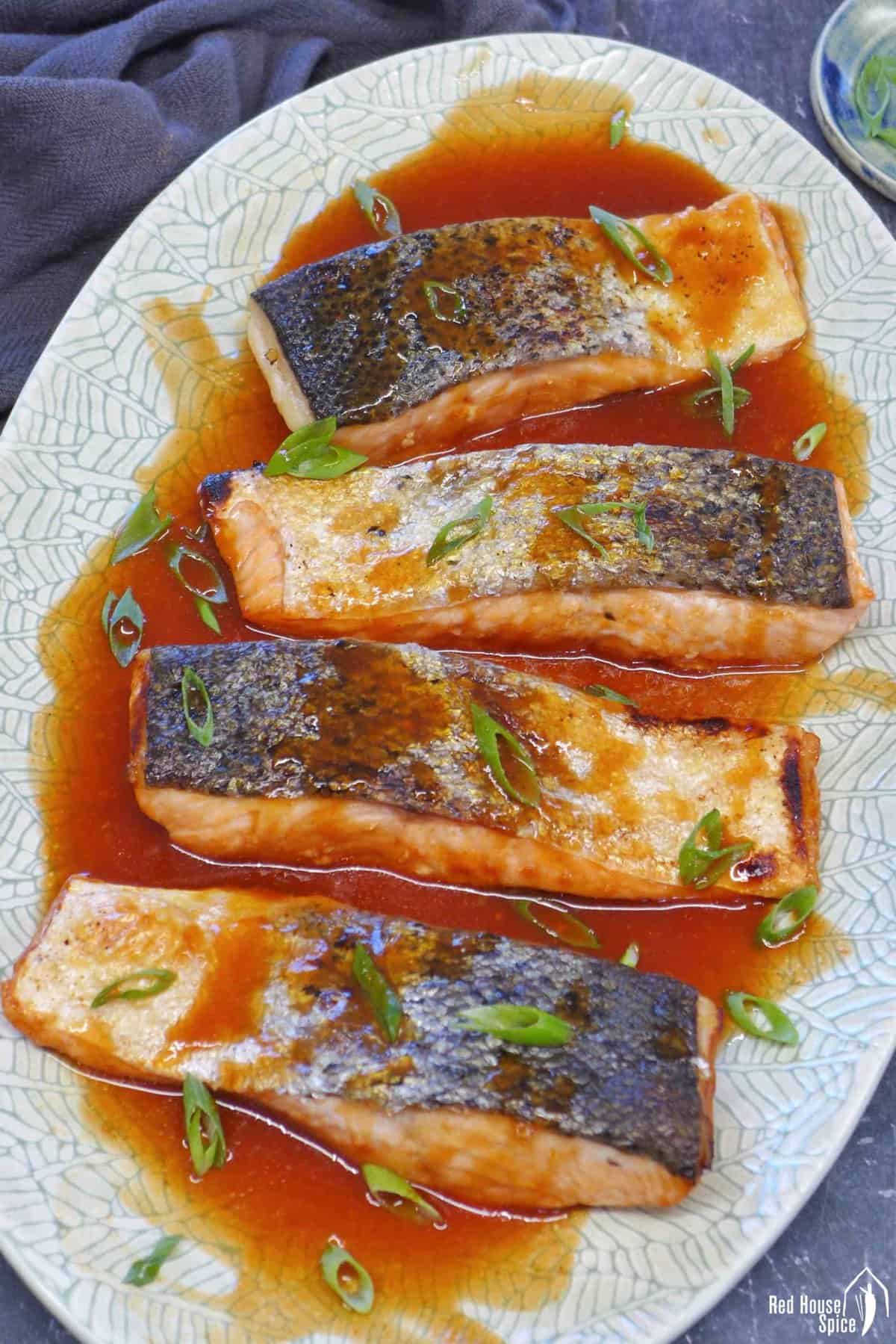 A plate of sweet and sour salmon.