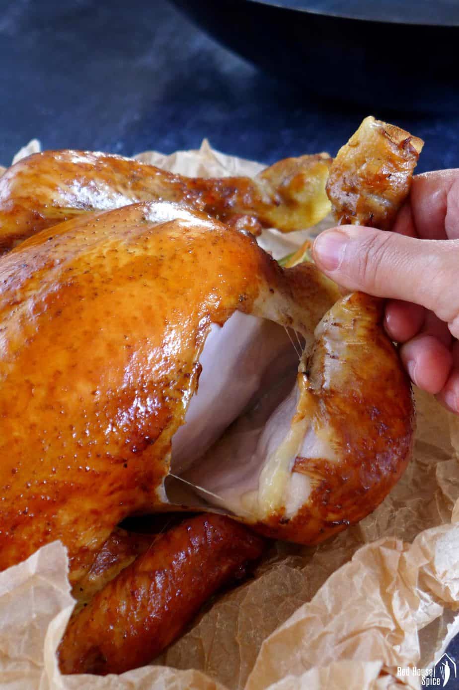 Pulling a leg off a smoked chicken