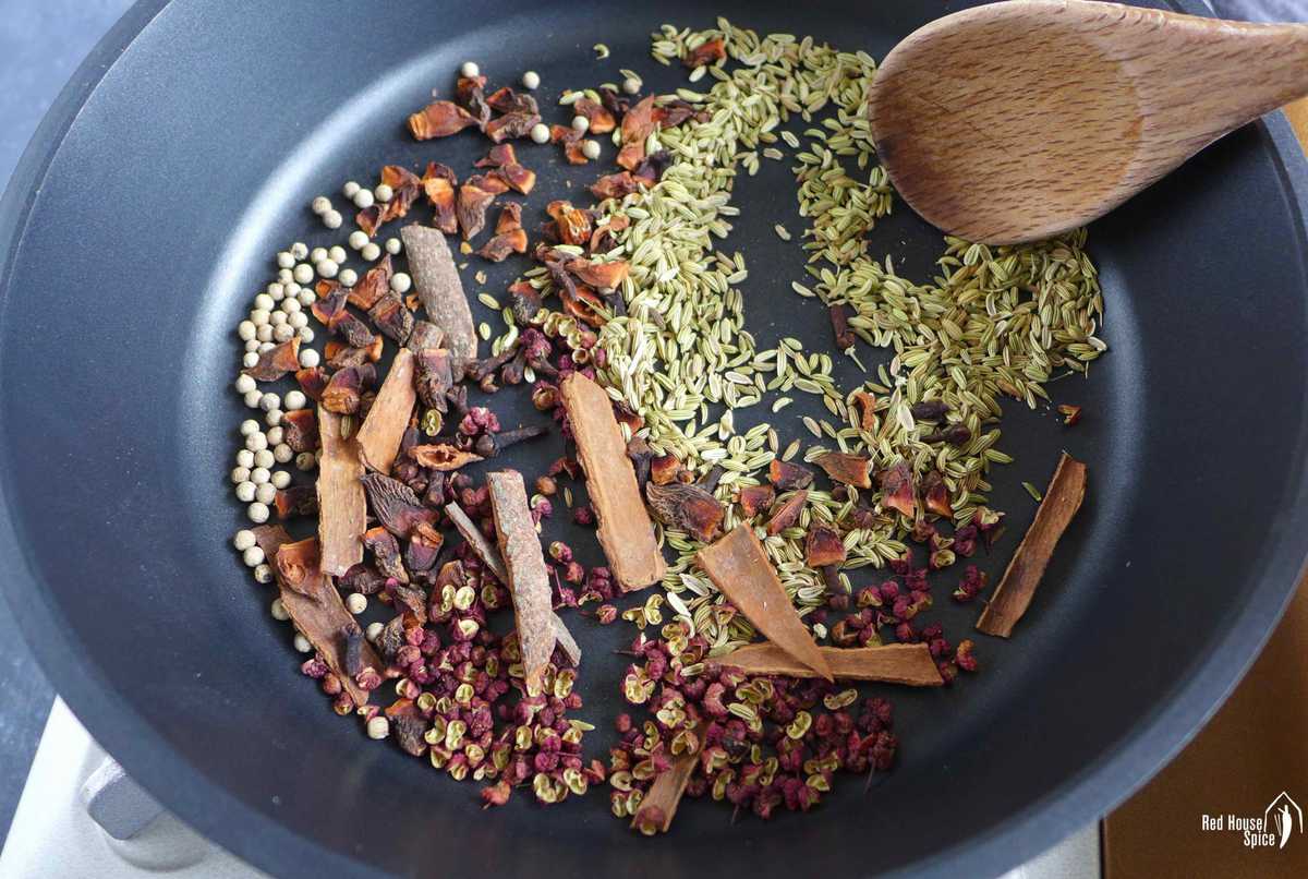 Toasting spices in a pan.