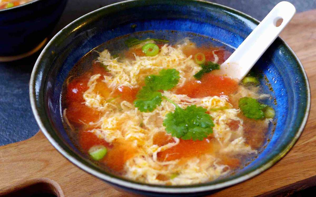 A bowl of tomato egg drop soup.
