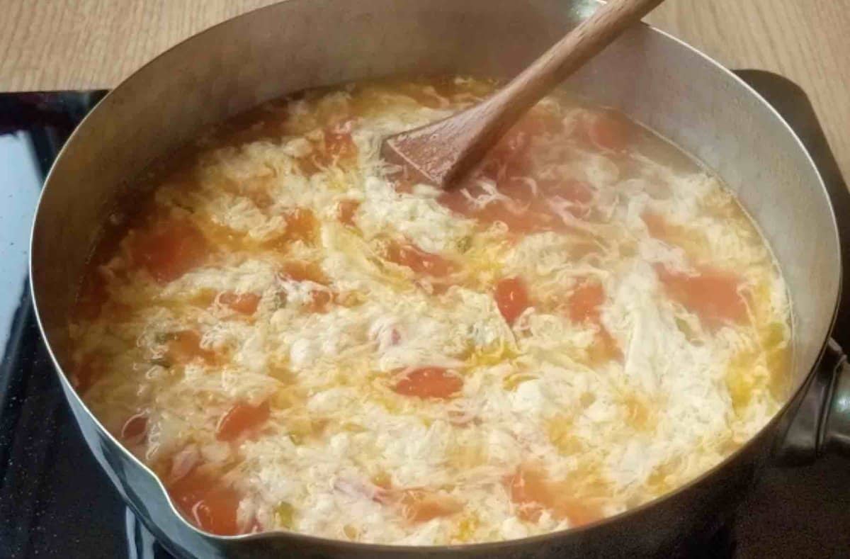 tomato egg drop soup in a pot.