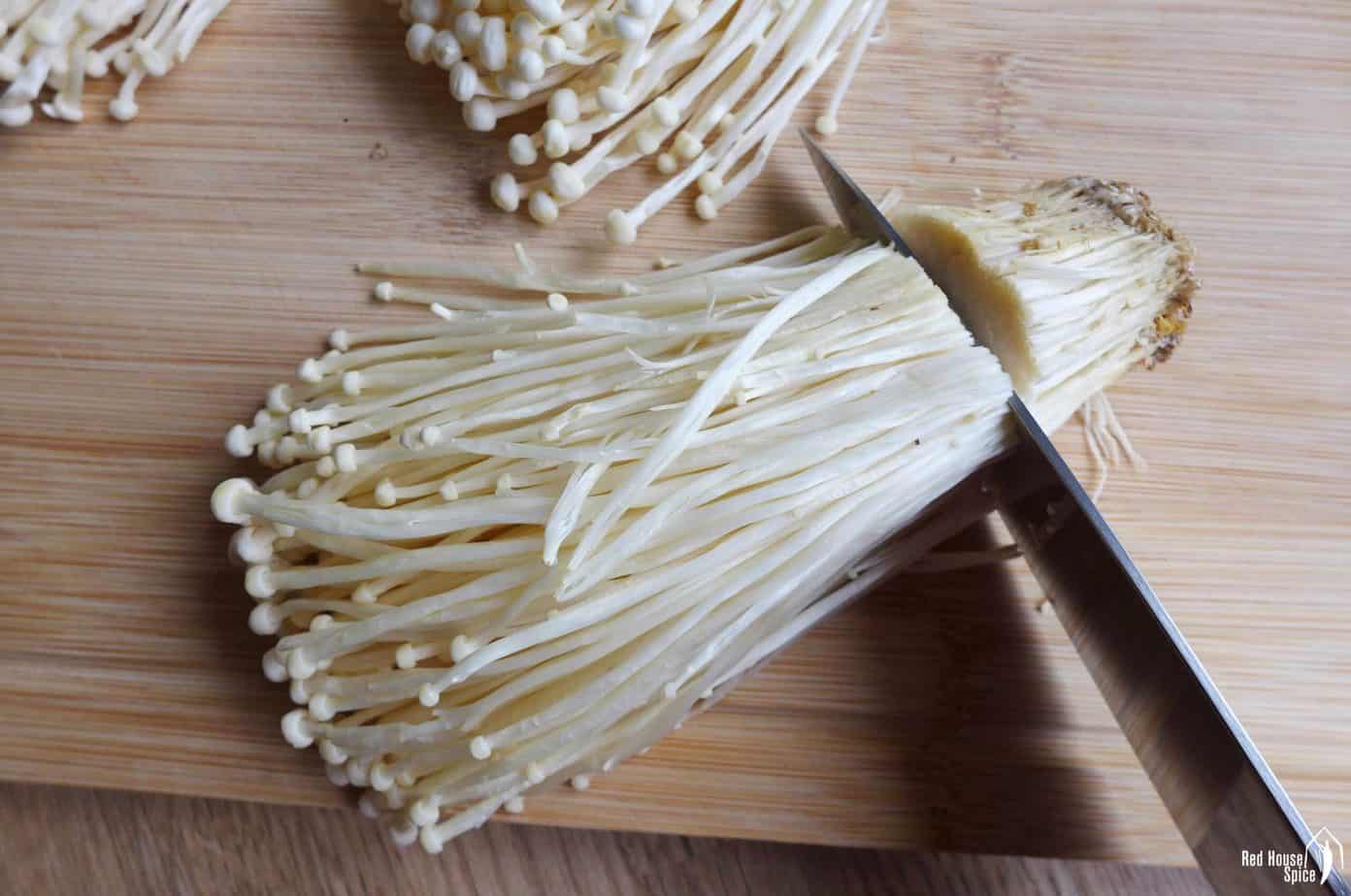 trimming off the root of enoki mushroom