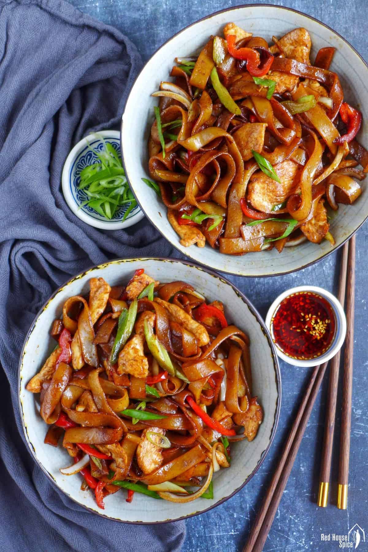 Two bowls of chicken fried rice noodles