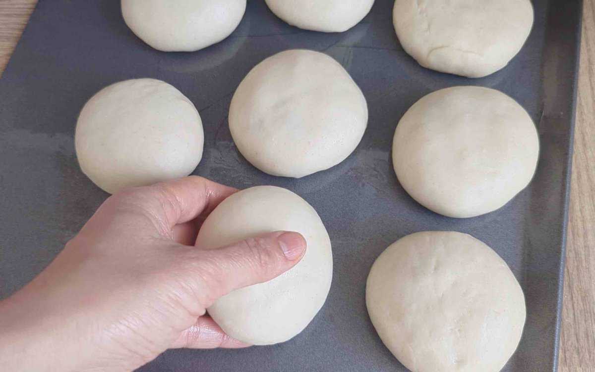 uncooked meat pies on a tray.