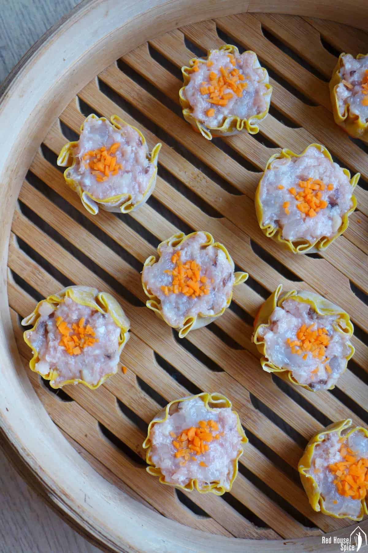 uncooked Siu Mai in a steamer