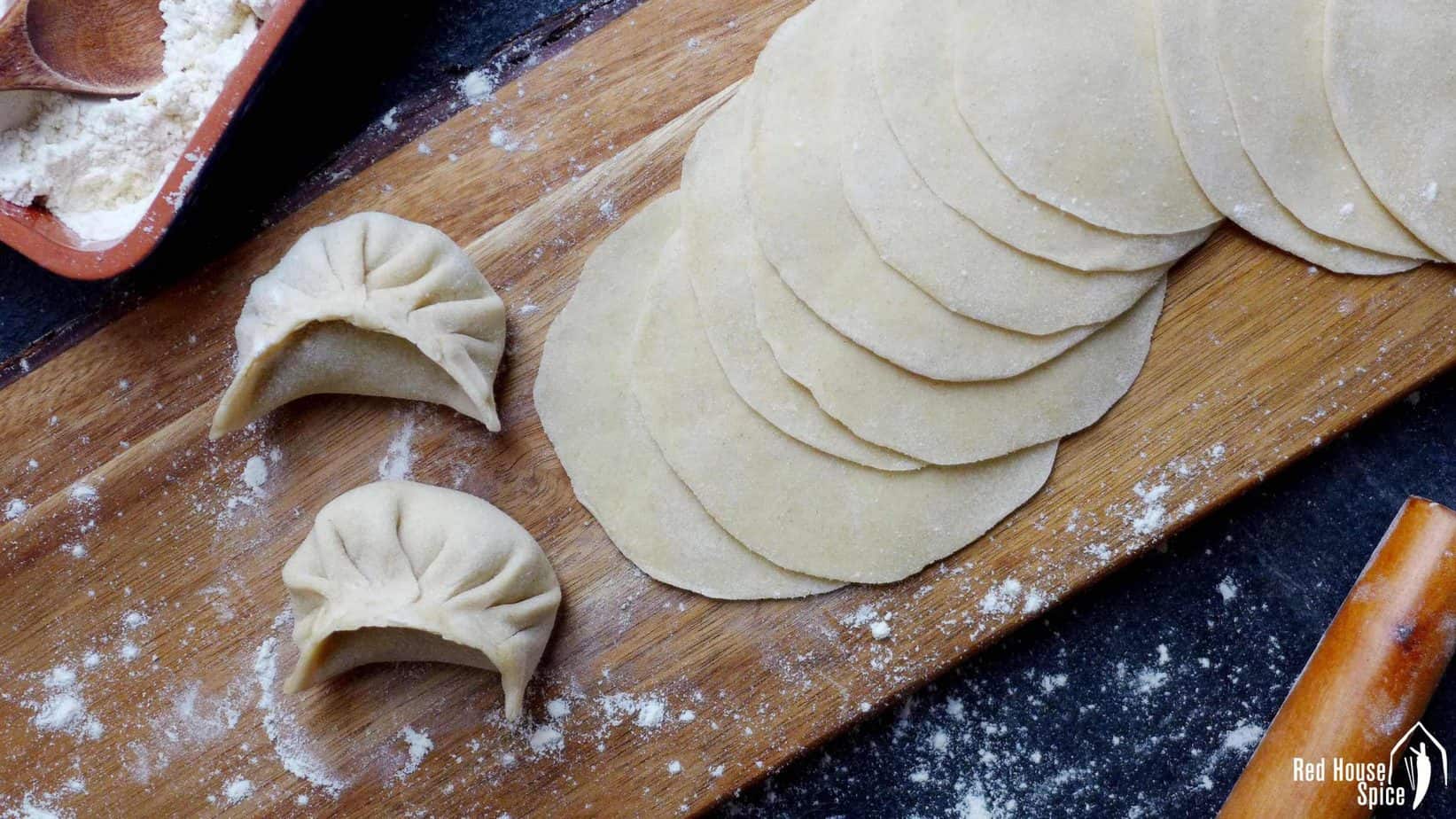 Homemade dumpling wrappers with 2 dumplings.