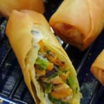 a spring roll cut open showing the filling inside.