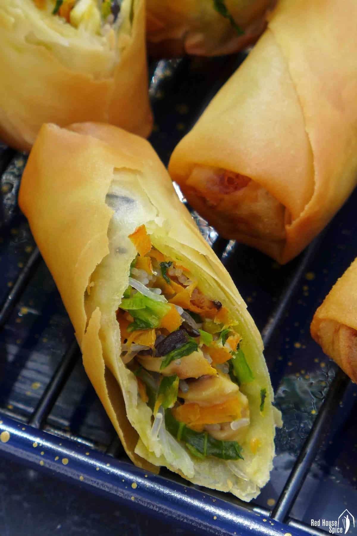 a spring roll cut open showing the filling inside.