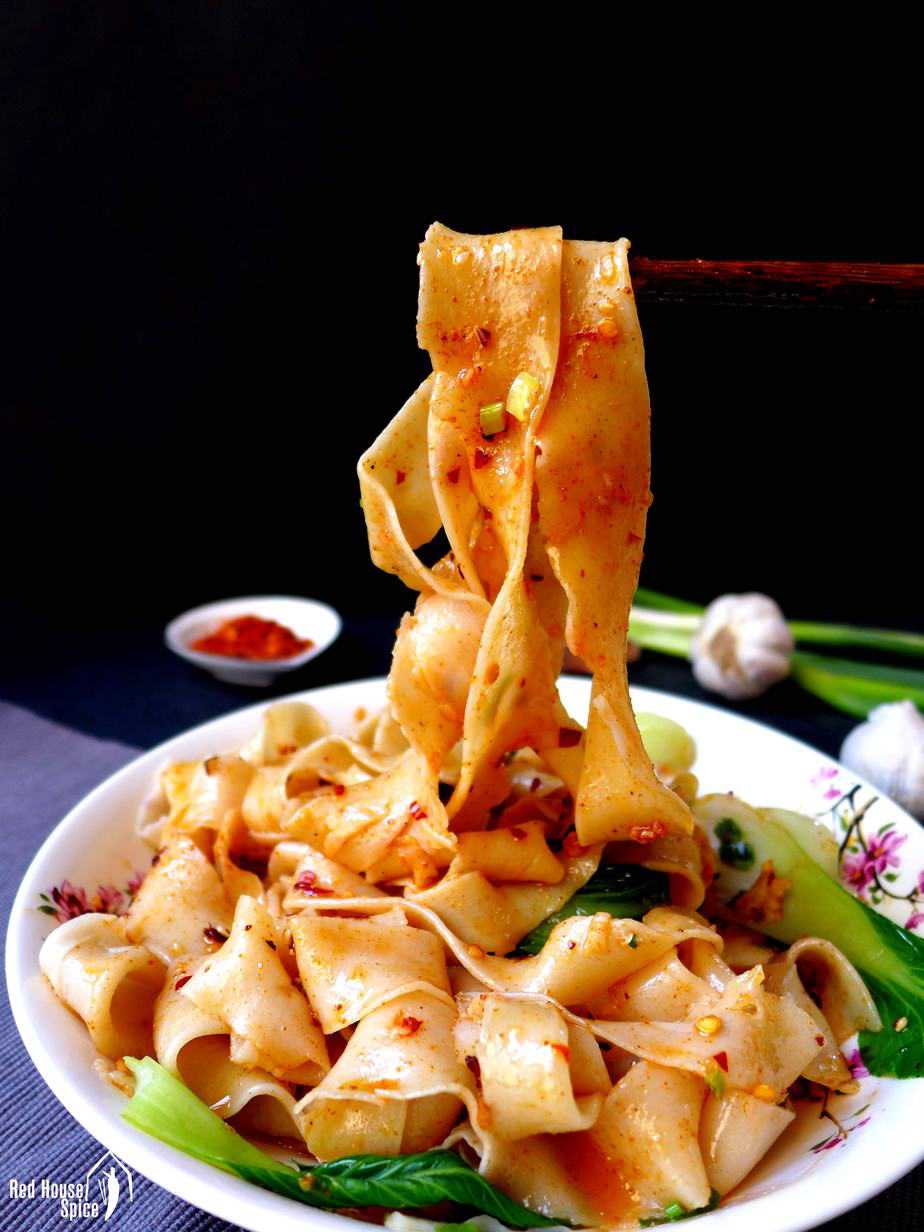 Thick, broad Biang Biang noodles covered with spicy dressing.