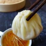 chopsticks picking up a soup dumpling