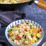 Yangzhou fried rice in a bowl and in a wok.