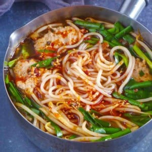 Yunnan rice noodle soup in a small pot.