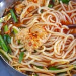 Yunnan rice noodle soup in a small pot.