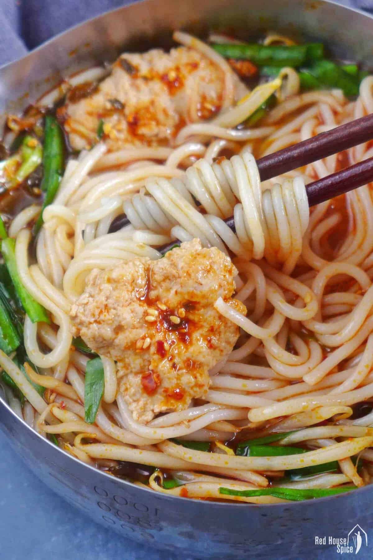 Yunnan rice noodle soup in a small pot.