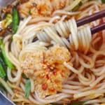 spicy rice noodle soup with meat and vegetables with overlay text that says Yunnan rice noodle soup.