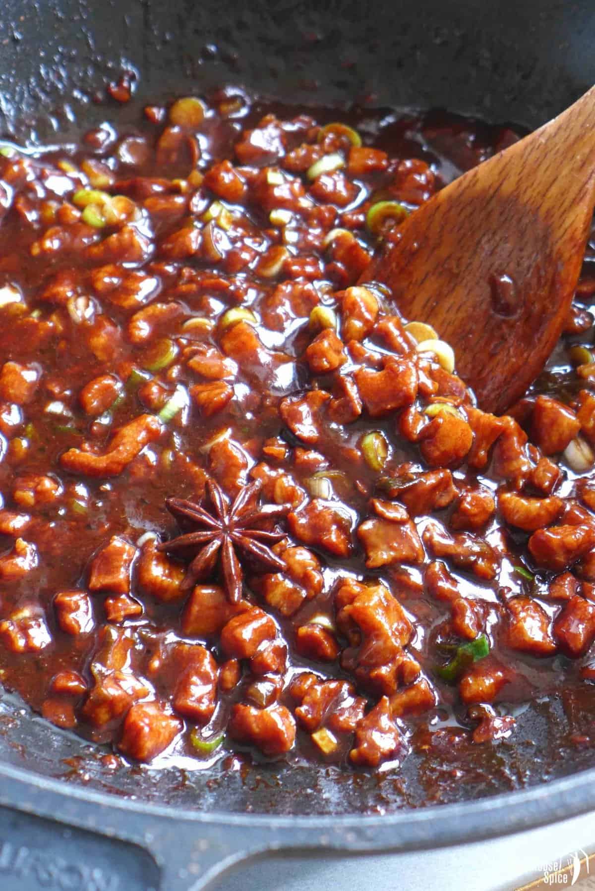 cooking pork in a thick brown sauce.
