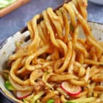 pulling noodles with chopsticks with overlay text that says zha Jiang noodles.